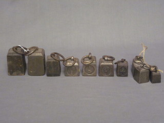 12 various square iron weights, 6 various iron weights, 2 x 7lb weights and 5 x 4lb weights