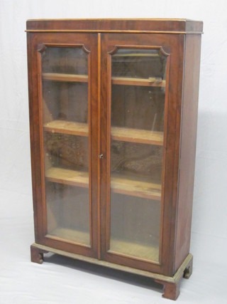 A 19th Century mahogany bookcase, the shelved interior  enclosed by glazed panelled doors, raised on bracket feet 34"