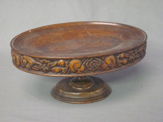 An oval carved oak dish raised on a column 14"