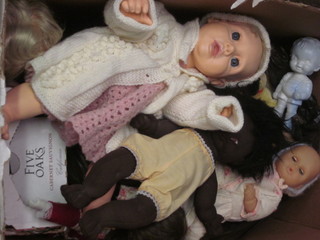 A box containing a large collection of dolls etc