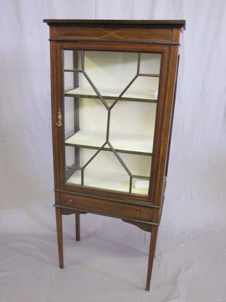 An Edwardian inlaid mahogany display cabinet fitted shelves  enclosed by astragal glazed panelled doors, the base fitted a  drawer and raised on square tapering supports 23"