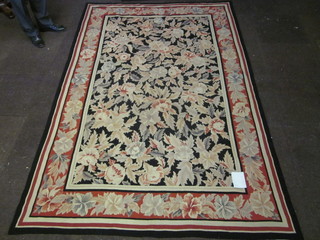 A black ground and floral patterned Aubusson style rug 103" x  67"