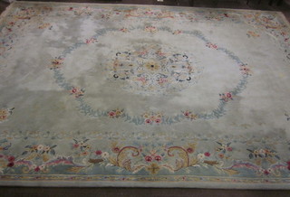 A green ground and floral pattern Indian carpet 216" x 143"