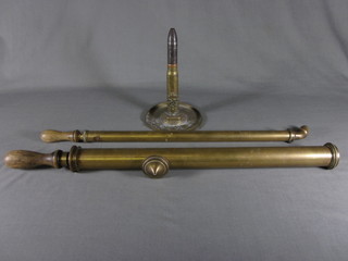 A brass table lighter in the form of an RAF canon shell, together  with 2 brass garden syringes