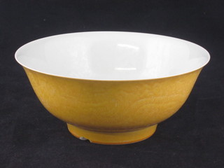 An Oriental yellow glazed circular bowl, the base with 6 character mark, large chip to base, 7"   ILLUSTRATED