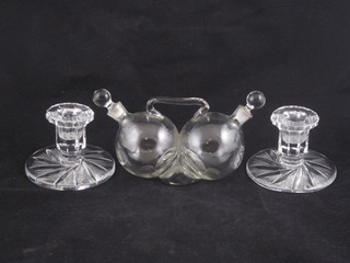 A pair of circular cut glass stub shaped candlesticks 3" and a globular shaped water and oil bottle