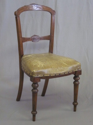A pair of Victorian walnut bar back dining chairs with carved  mid rails and upholstered seats
