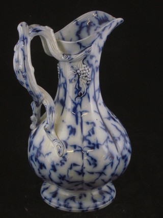A 19th Century blue and floral glazed jug with crabstock handle  9"