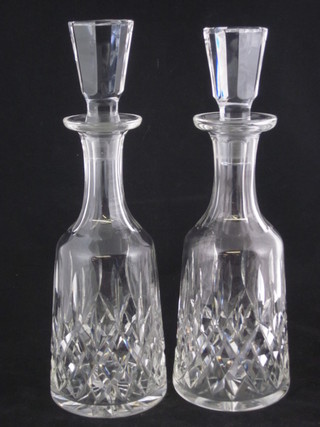 A pair of cut glass club shaped decanters and stoppers