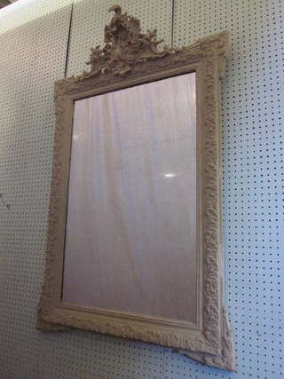 A rectangular plate mirror contained in a decorative white plaster frame 47" x 28"