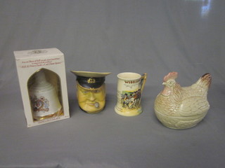 A Winston Churchill pottery character jug, a Crown Devon  Widdicombe Fair mug, an empty Bells Whisky decanter to commemorate the Wedding of Prince Charles and Lady Diana  and a pottery egg store