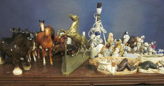 A brass figure of a rearing horse and a collection of pottery figures of horses, animals etc