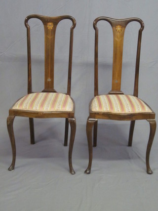 A pair of Edwardian inlaid mahogany slat back dining chairs with upholstered drop in seats