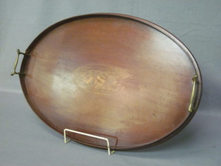 An oval Edwardian inlaid mahogany twin handled tea tray 22"