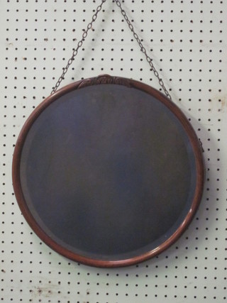 A 1930's circular bevelled plate mirror contained in an oak frame  15"