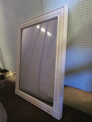 A rectangular plate mirror contained in a white painted frame 38" x 30"