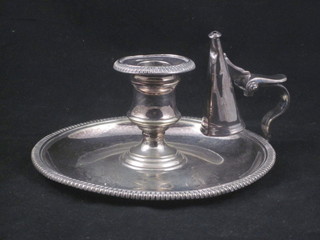 A silver plated chamber stick with snuffer