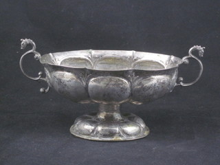 An 18th Century embossed silver twin handled bowl, raised on a spreading foot with armorial decoration 6", unmarked  ILLUSTRATED