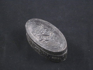 An oval embossed silver box and cover the lid decorated a mask, import marks, 2 ozs