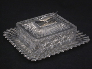 A rectangular cut glass sardine dish, raised on an embossed  base, chip to dish,