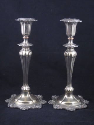A pair of Rococo style silver candlesticks with detachable sconces  10"
