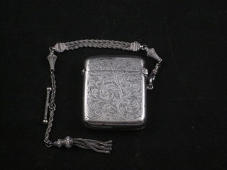 An engraved silver vesta case, Birmingham 1913, hung on a  Langtree chain