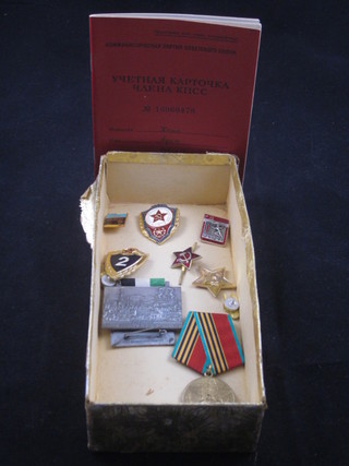 A Soviet Russian commemorative medal, 8 various Soviet  Russian badges and a Party members record card