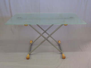 A metal and glass X framed adjustable dining/coffee table with plate glass top 51"