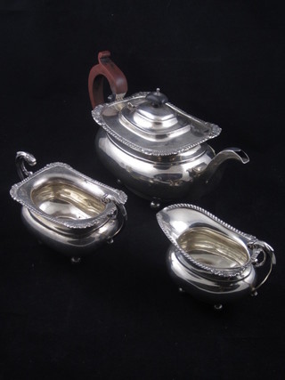 An oval silver 3 piece tea service, raised on bun feet Birmingham 1915, 30 ozs