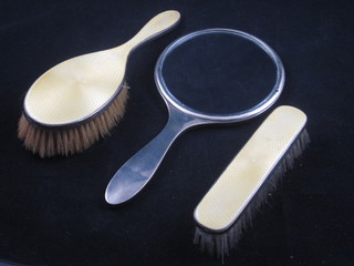 A yellow enamelled and silver backed 3 piece dressing table set  with hand mirror, hair brush and clothes brush, Birmingham  1926