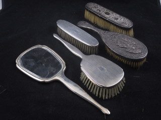 A silver backed 3 piece dressing table set with hand mirror, hair  brush and clothes brush with engine turned decoration and an  Eastern hair brush and clothes brush