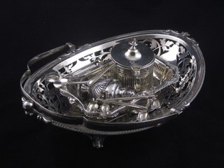 A pierced and boat shaped silver plated cake basket with swing handle, a rectangular dish with swin handle, mustard pot,  pepperette, pair of knife rests in the form of dogs etc