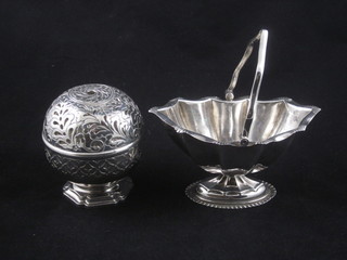 A pierced silver plated string box and a boat shaped sugar bowl  with swing handle