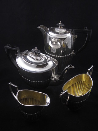A Britannia metal 4 piece tea service of oval form and demi-reeded decoration comprising teapot, hotwater jug, milk jug  and sugar bowl