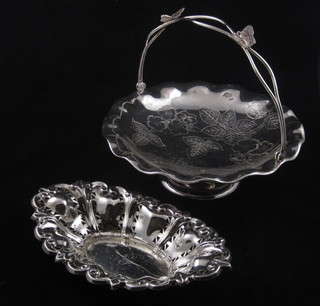 A pierced boat shaped silver plated dish and a silver plated cake basket with swing handle