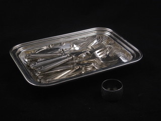 A rectangular silver plated dish containing 9 silver handled forks and other forks