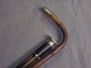 An inlaid hardwood cane with silver handle and 1 other