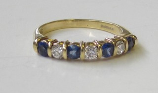 An 18ct yellow gold dress ring set blue and white stones