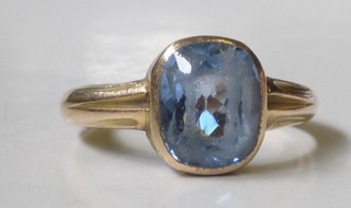 A gilt metal dress ring set a blue stone