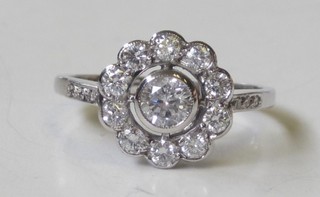 An 18ct white gold cluster ring set diamonds, surrounded by numerous diamonds, approx 0.70ct