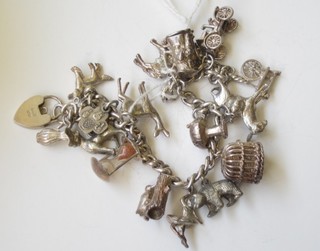 A silver curb link bracelet hung numerous charms
