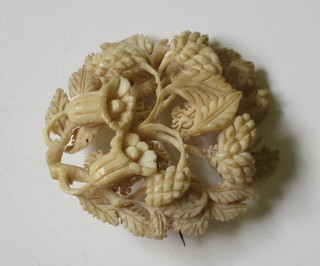 A Victorian carved bone brooch in the form of a flower