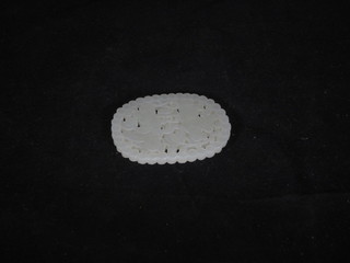 An oval and carved pierced section of jade 2"