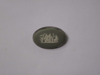 An oval green Wedgwood brooch, the reverse marked 73