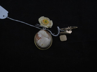A shell carved cameo portrait brooch contained in a gilt metal  mount, a pair of gold cufflinks, a carved ivory brooch in the  form of a flower head and a "gold" bar brooch