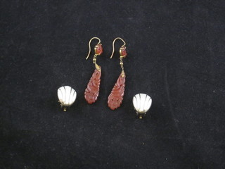 A pair of carved Cornelian earrings and a pair of gilt metal earrings