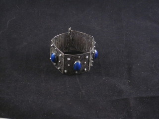 A silver filigree bracelet set cabouchon cut blue stones