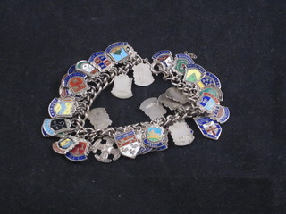 A silver curb link charm bracelet hung silver and enamelled  charms