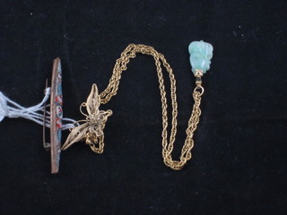 A jade pendant hung on a gilt metal chain, a micro mosaic  brooch and a gilt brooch