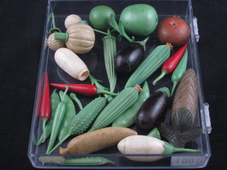 A collection of various carved ivory vegetables